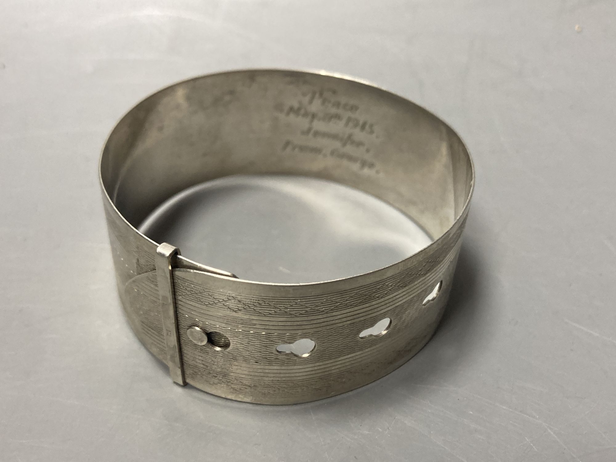 A cased silver handled button hook and shoe horn, a silver and enamel hand mirror, a silver bangle and small silver model ship